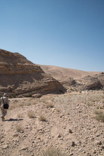 David Kennedy following the faint trace of the profile of a road into the Wadi Sueida. Photograph: Rebecca Banks.